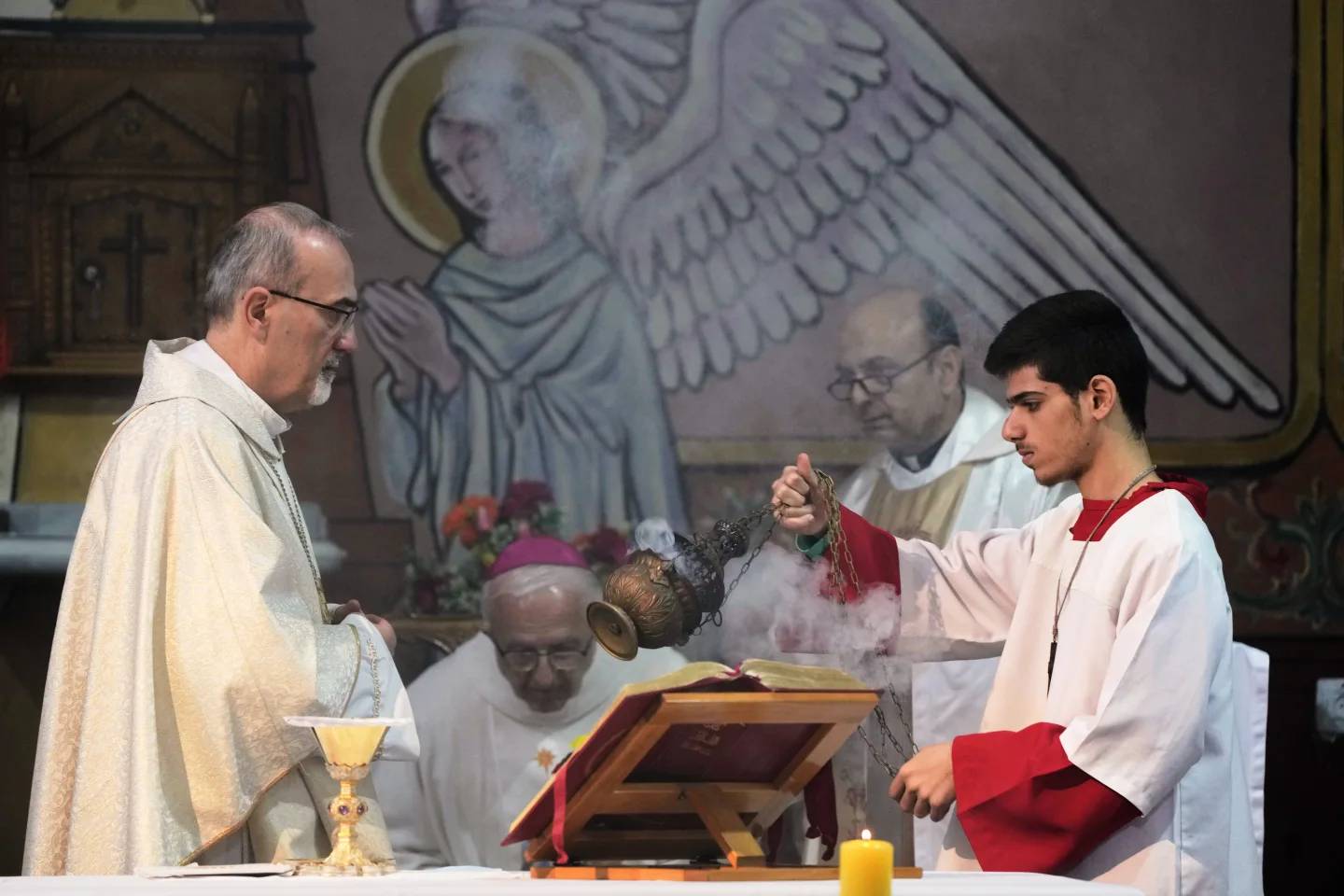 Cardinal Pierbattista Pizzaballa, the Latin Patriarch of Jerusalem, left, leads a Christmas Eve Mass at the Holy Family Catholic Church in Gaza City, Sunday, Dec. 21, 2025. (Credit: Jehad Alshrafi/AP.)
