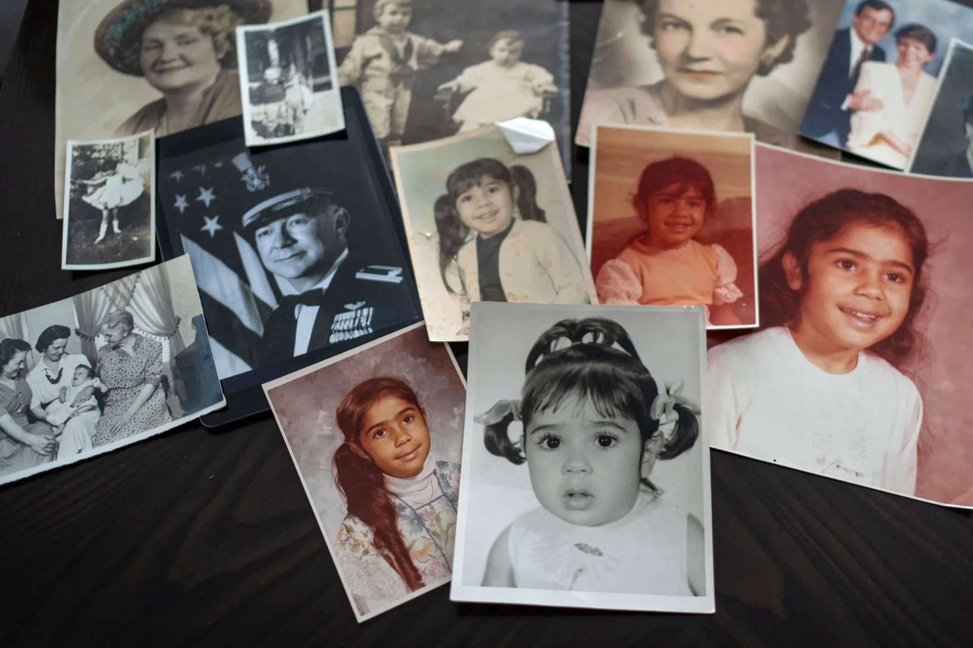 Childhood photos of a woman adopted as a toddler by an American war veteran, who he found in the 1970s in an Iranian orphanage and raised as a Christian, are displayed along with a picture of her father, a WWII Air Force veteran, at left, and additional family photos, Monday, June 24, 2024, in Henderson, Nev. (Credit: David Goldman/AP.)