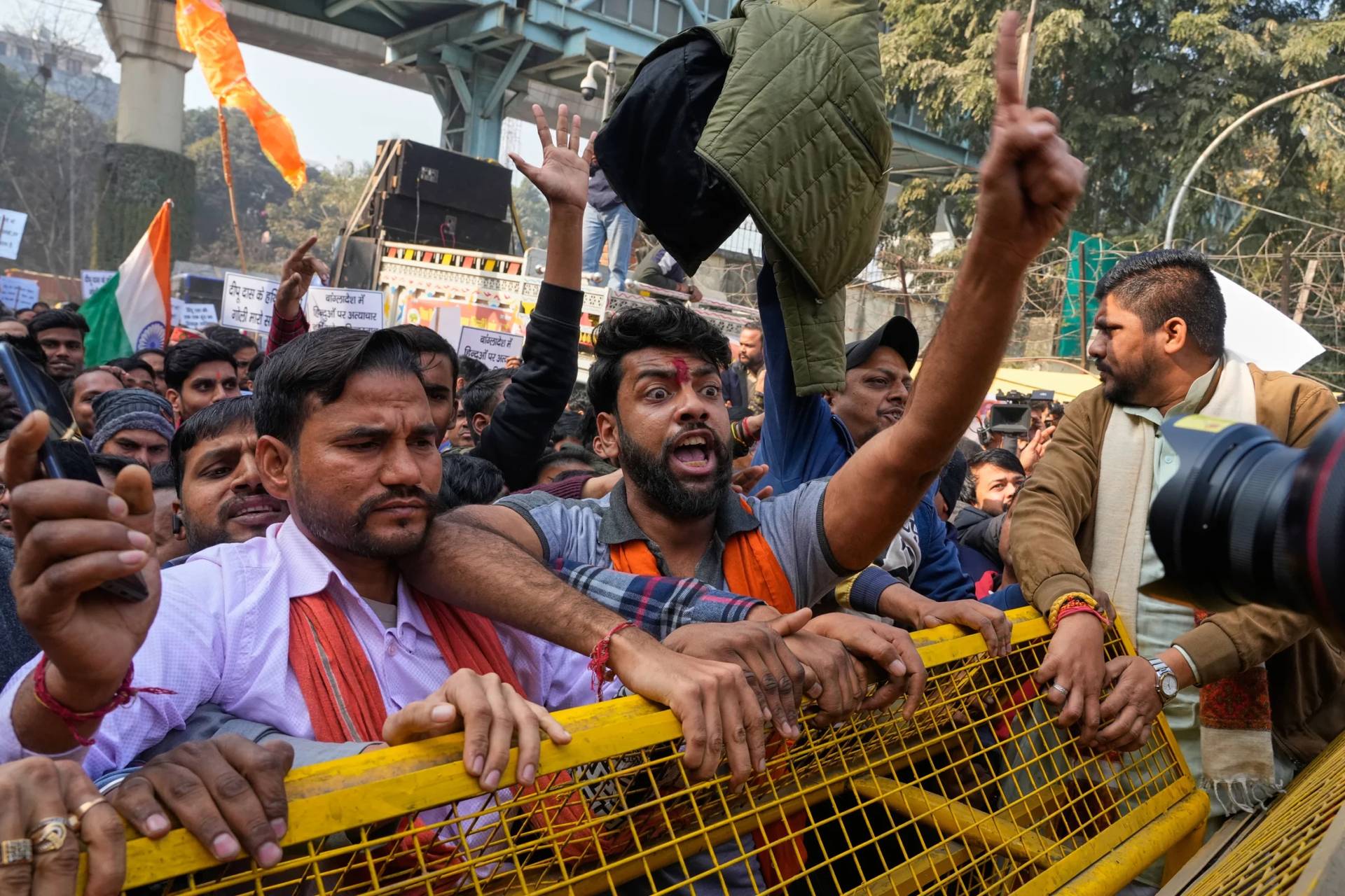 Activists of Vishwa Hindu Parishad, a prominent right-wing Hindu nationalist organization, shout slogans during a protest near Bangladesh High Commission accusing Bangladeshi groups of wrongly targeting Indians, in New Delhi, India, Tuesday, Dec.23, 2025. (Credit: Manish Swarup/AP.)
