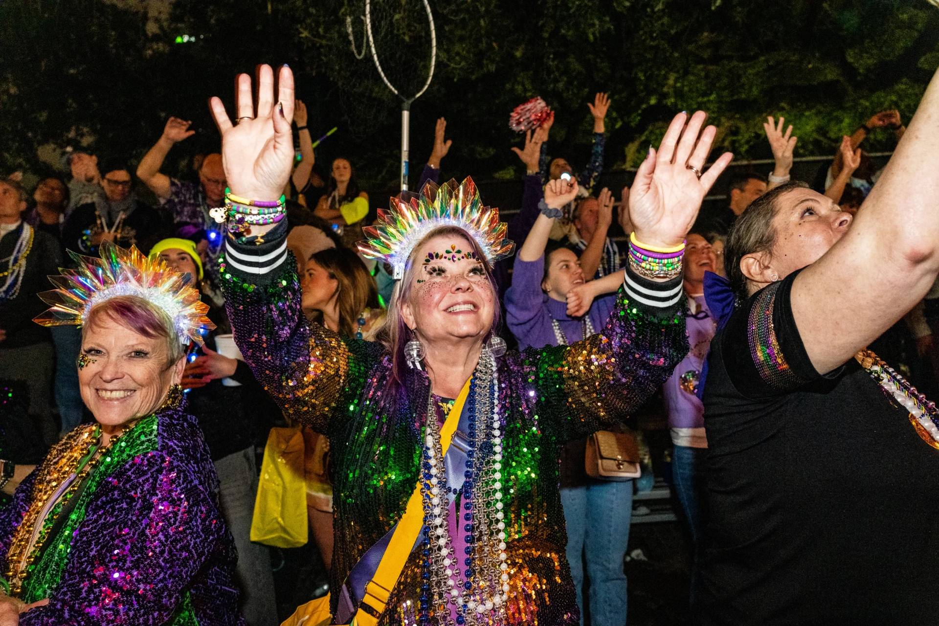 Attendees participate in the annual Krewe of Muses parade during the Mardi Gras season on Thursday, Feb. 12, 2026, in New Orleans. (Credit: Photo by Amy Harris/Invision/AP.)