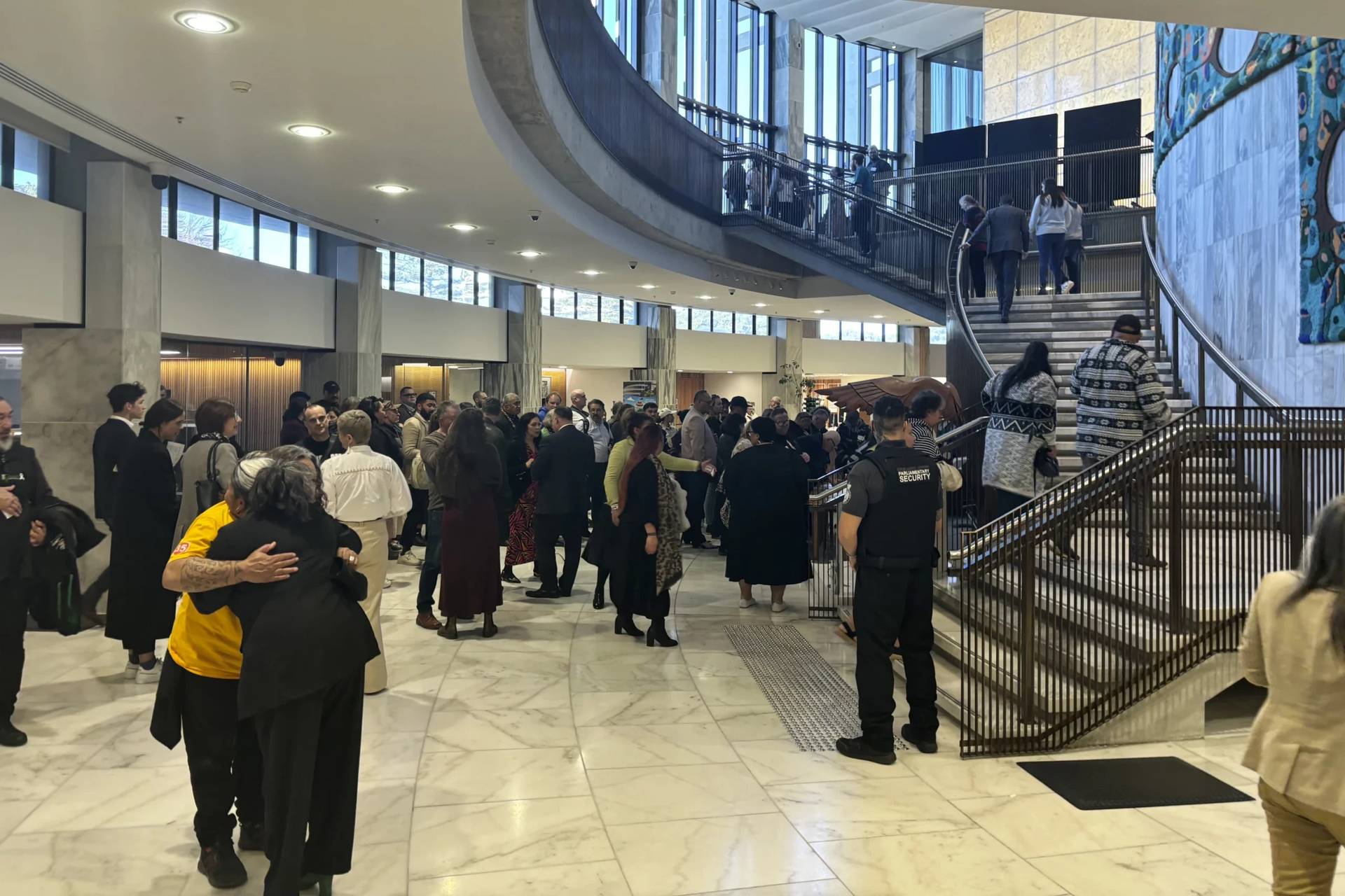 People arrive at Parliament in Wellington, New Zealand, on Wednesday, July 24, 2024, for the tabling of a wide-ranging independent inquiry into the abuse of children and vulnerable adults in care over the span of five decades wrote in a blistering final report. (Credit: Charlotte Graham-McLay/AP.)