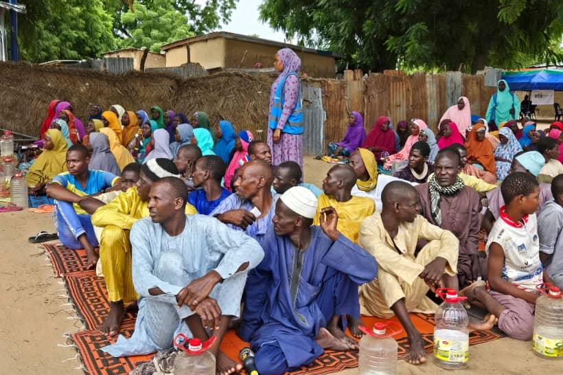People wait to receive food donations from the United Nations World Food Program in Damasak, northeastern Nigeria, Oct. 6, 2024. (Credit: Chinedu Asadu/AP.)