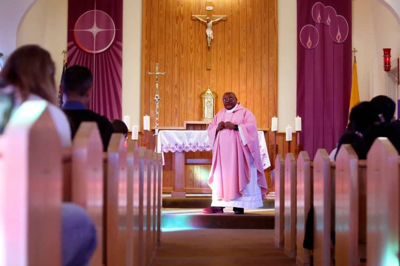 Athanasius Abanulo, from Nigeria, celebrates Mass at Holy Family Catholic Church in Lanett, Ala., on Sunday, Dec. 12, 2021. He is one of numerous international clergy helping ease a U.S. priest shortage by serving in Catholic dioceses across the country. (Credit: Jessie Wardarski/AP.)