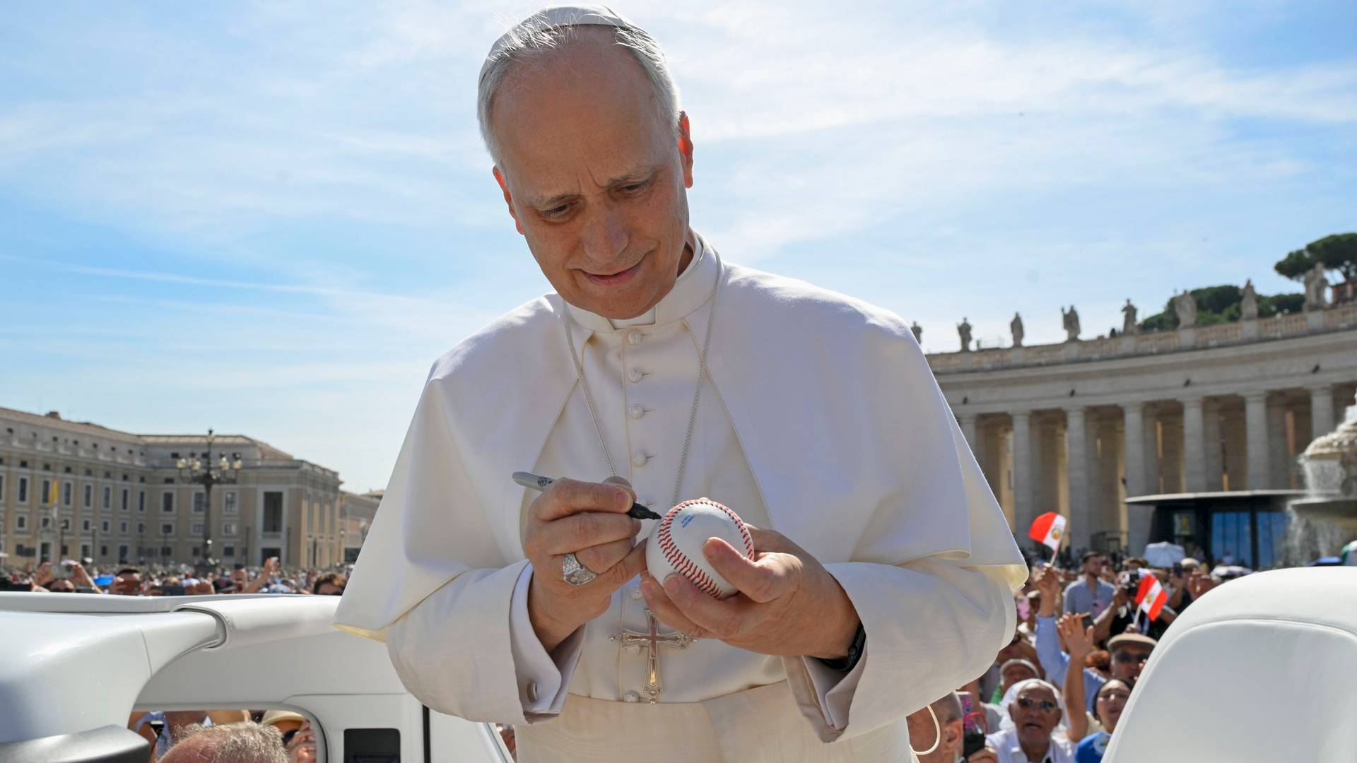 Pope Leo XIV signs a baseball in St. Peter's Square at the Vatican before his weekly general audience June 4, 2025. (Credit: Vatican Media.)