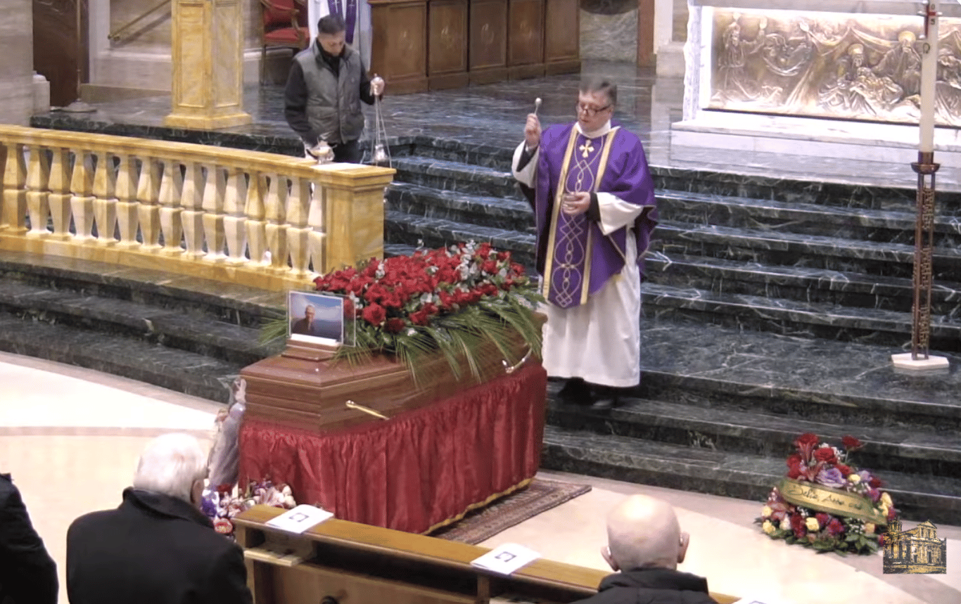 Father John Wauck blesses the coffin of John L. Allen Jr. on Jan. 26, 2026, in Sant’Eugenio basilica in Rome. (Credit: YouTube.)